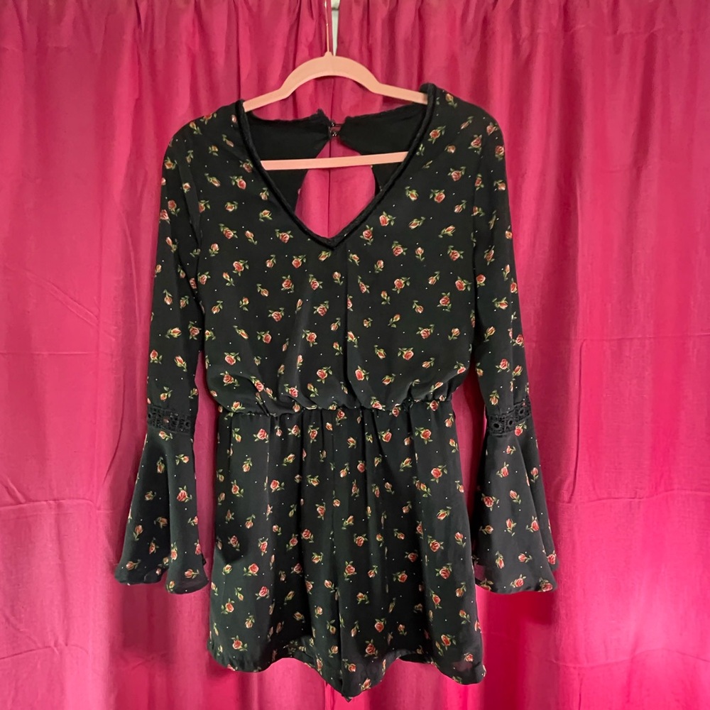 Cute black romper with flowers around it long sleeve V-neck.